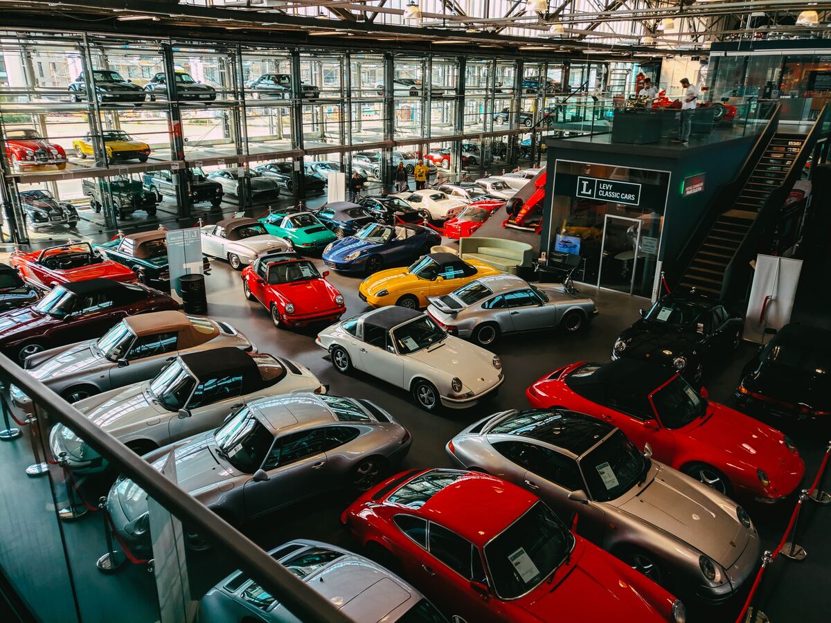 A lot of classic cars displayed in a dealership