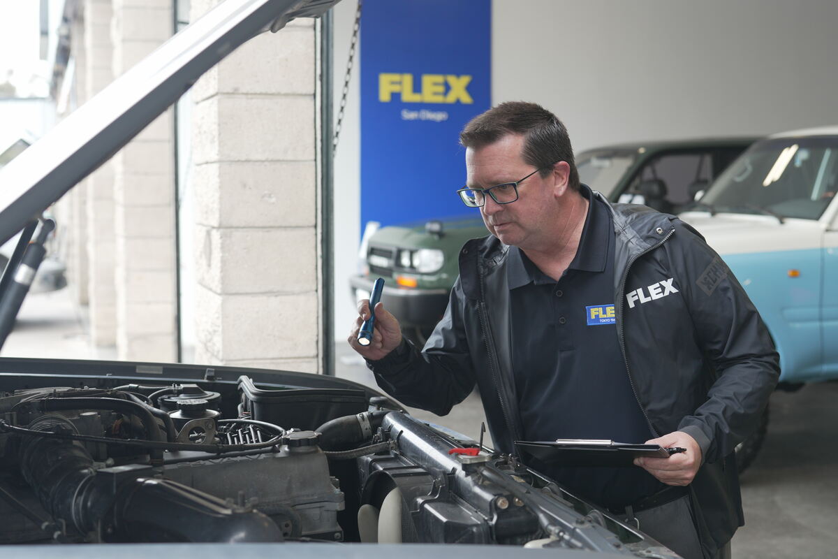 A mechanic inspecting a vehicle at FLEX Automotive in San Diego