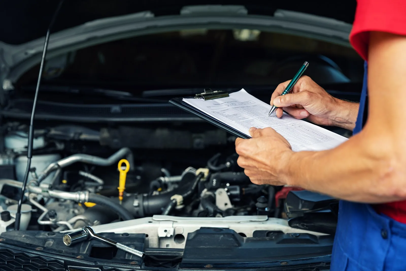 A Mechanic inspecting a used Toyota Sequoia for sale