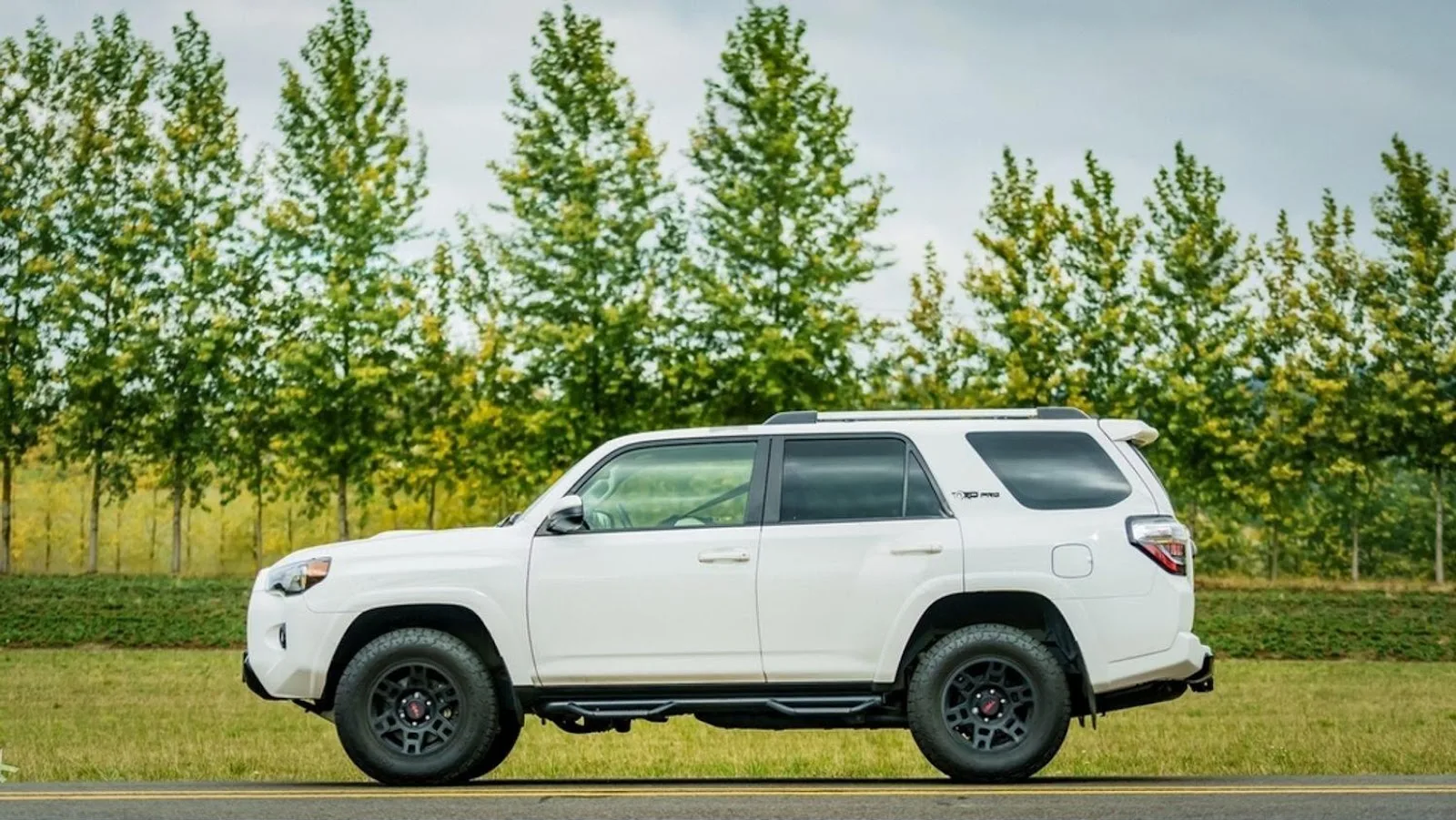 A white Toyota 4Runner parked on a highway