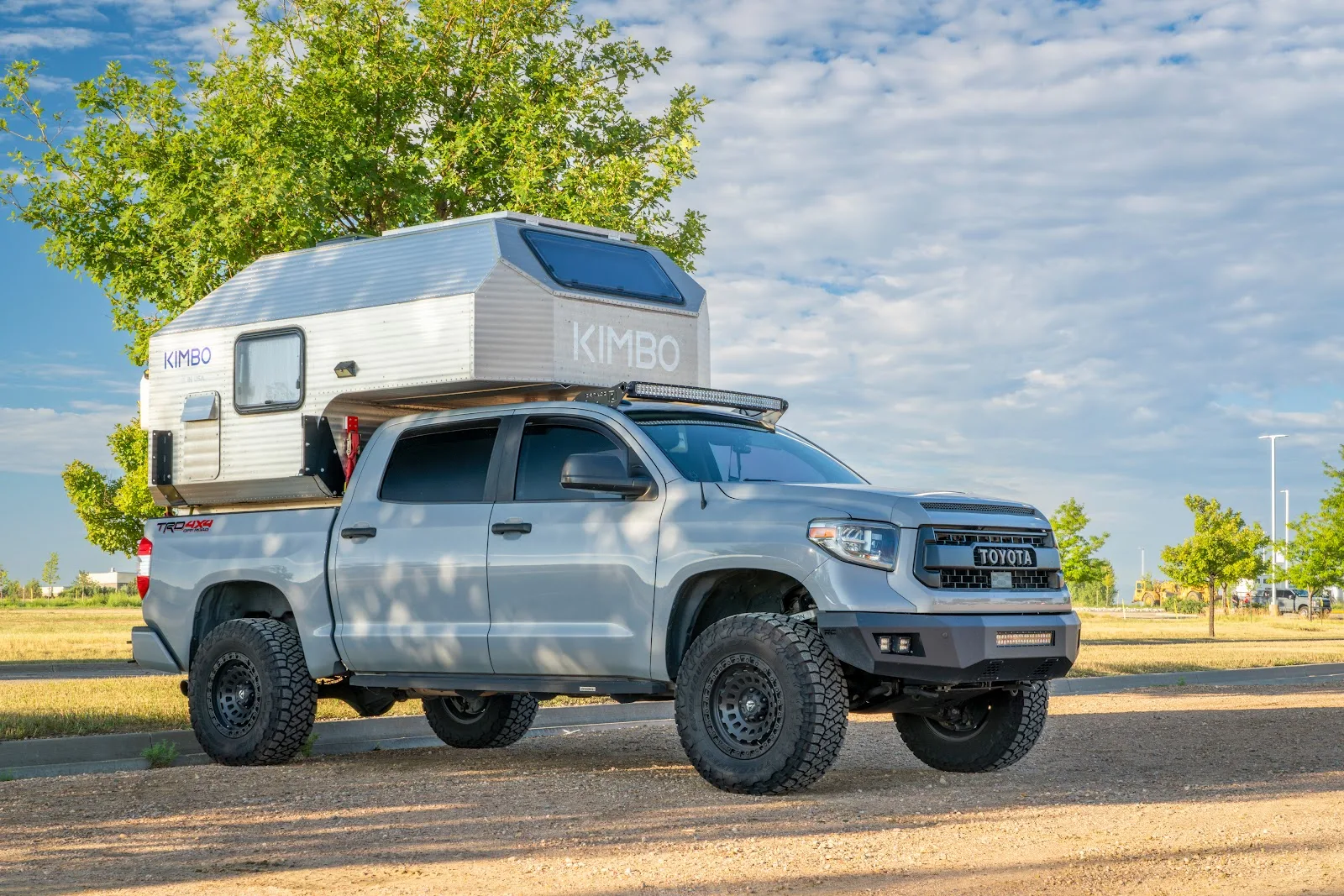 Toyota Tacoma with an aluminum camper on top