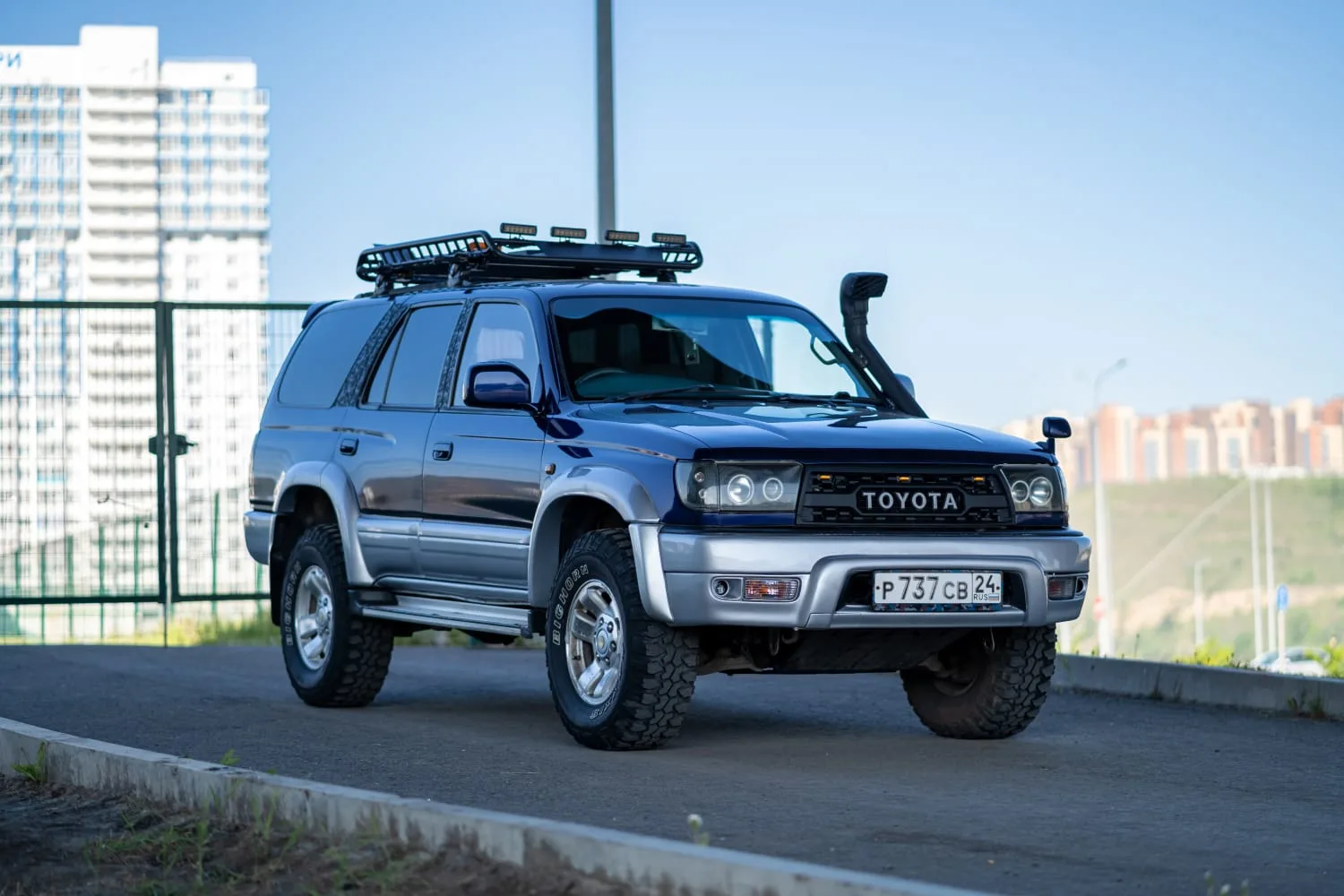 black toyota hilux surf front three quarter view