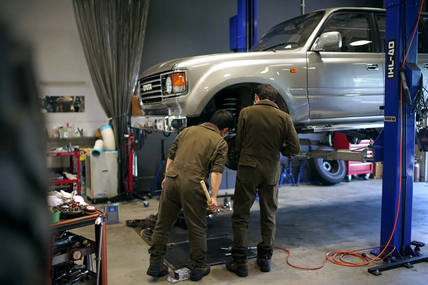 A mechanic at FLEX Automotive working on a Toyota Land Cruiser