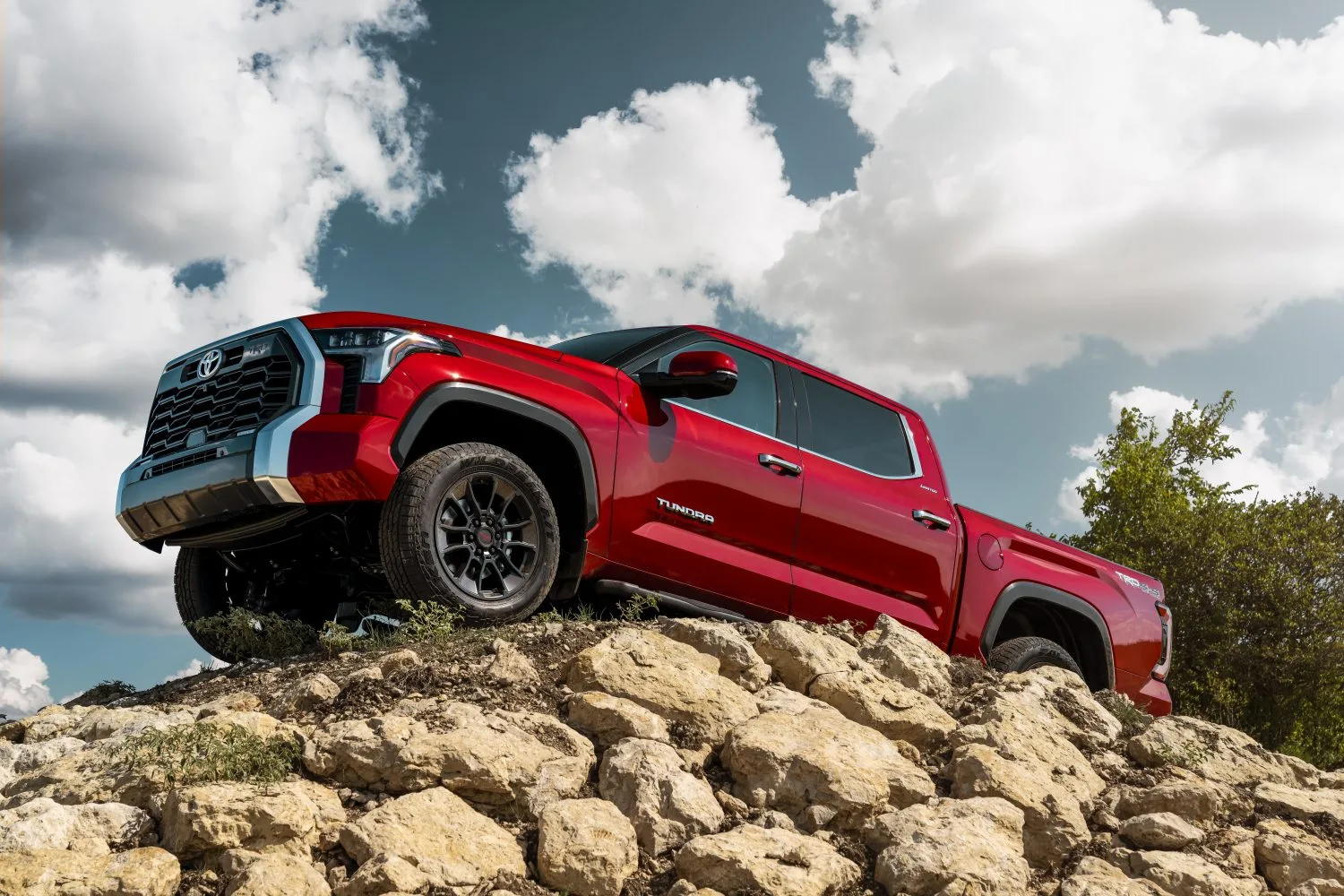 Red Toyota Tundra Parked alongside a beach